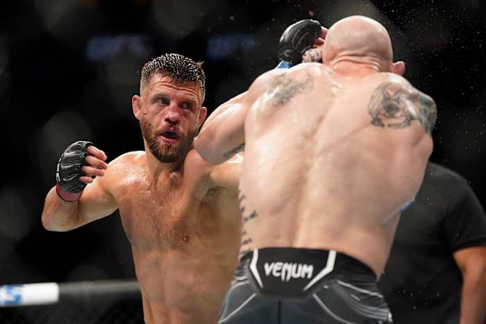 Josh Emmett (blue gloves) fights Calvin Kattar (red gloves) in the featherweight main event fight during UFC Fight Night at Moody Center.